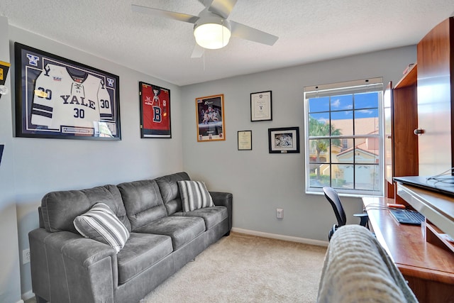 living room featuring a textured ceiling, light colored carpet, and ceiling fan