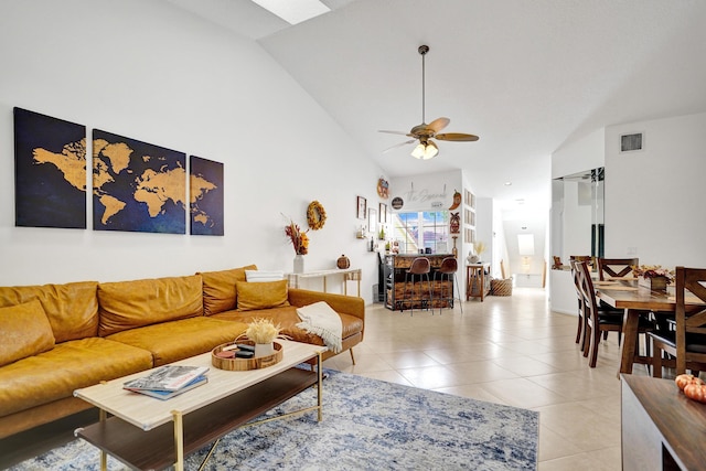 tiled living room with high vaulted ceiling and ceiling fan