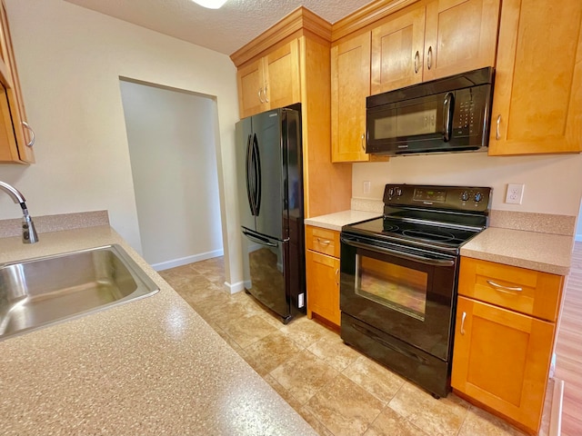 kitchen featuring black appliances, sink, and a textured ceiling