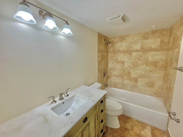 full bathroom featuring vanity, toilet, and tiled shower / bath