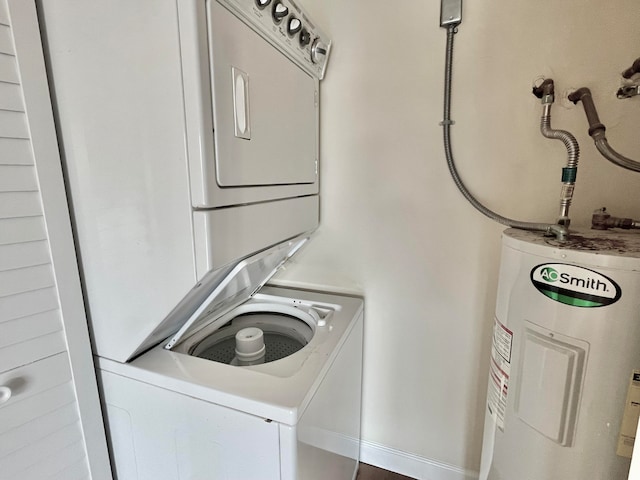 clothes washing area with stacked washer and dryer and water heater