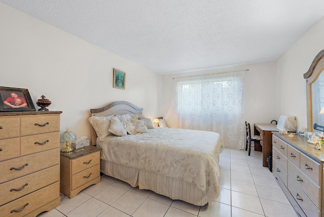 bedroom with light tile patterned floors and a textured ceiling