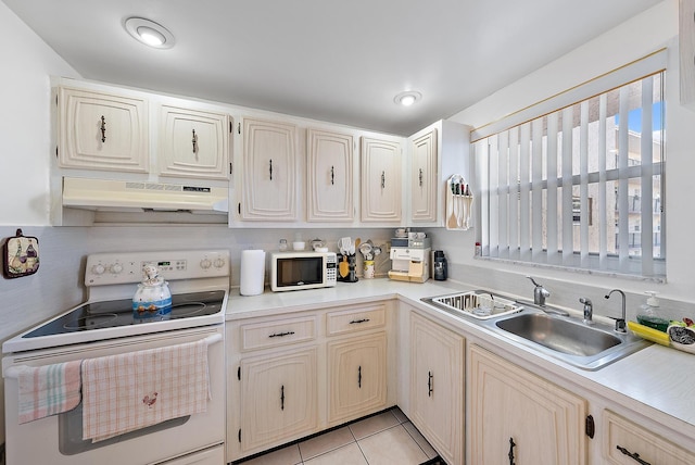 kitchen with light tile patterned floors, white appliances, sink, and extractor fan