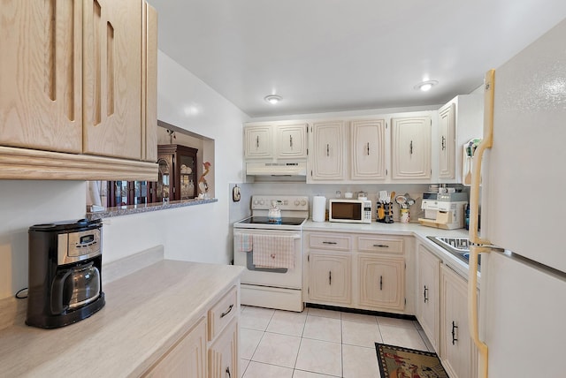 kitchen with light tile patterned flooring and white appliances