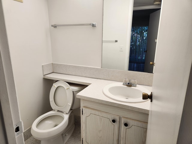 bathroom with tile patterned floors, vanity, and toilet