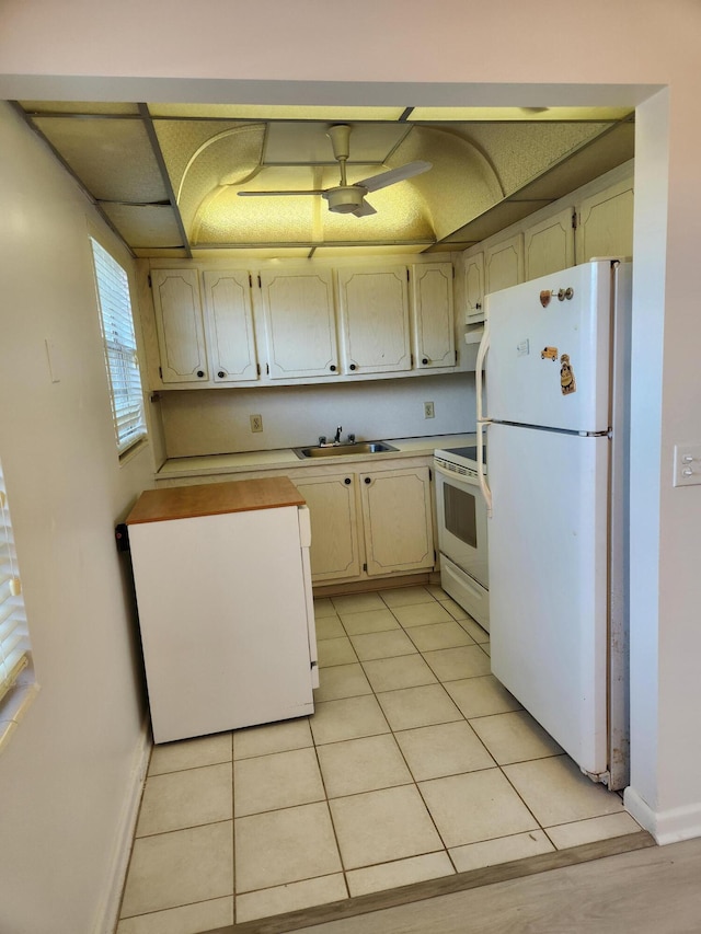 kitchen featuring light tile patterned floors, white appliances, ventilation hood, and sink