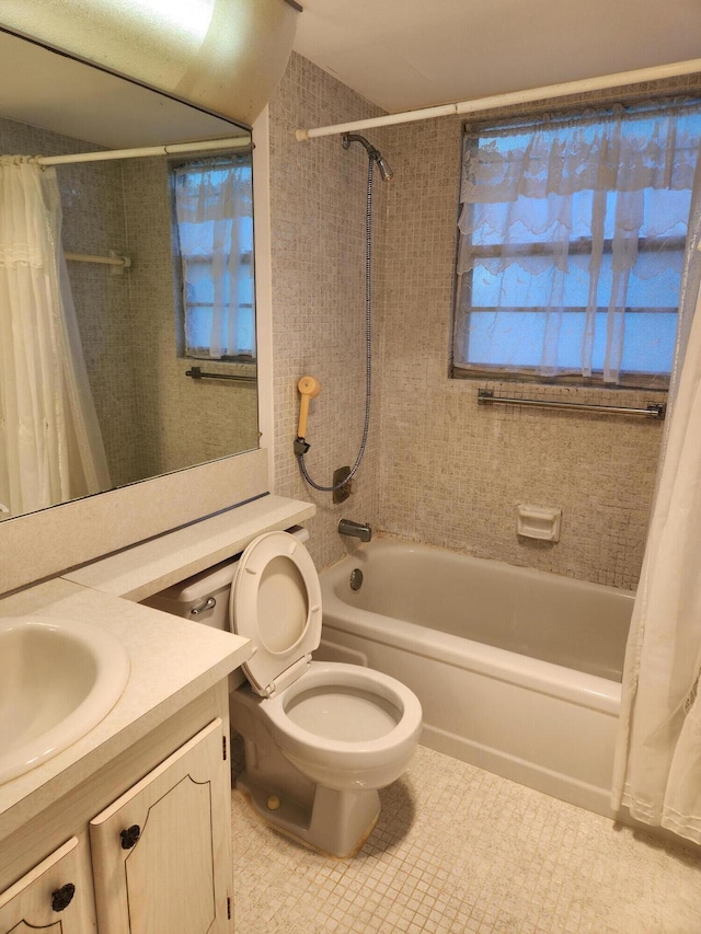 full bathroom with tile patterned flooring, vanity, toilet, and shower / bath combo with shower curtain