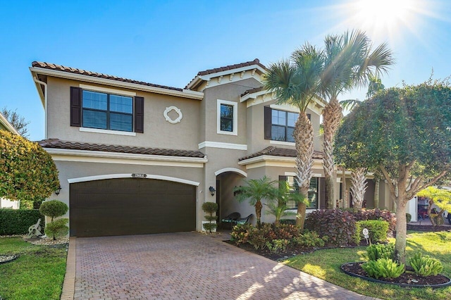 mediterranean / spanish-style home with a garage