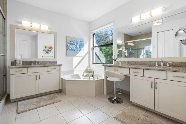 bathroom featuring tile patterned flooring, vanity, and separate shower and tub