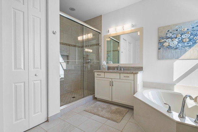 bathroom with tile patterned flooring, vanity, and shower with separate bathtub