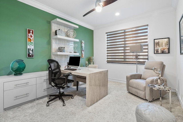 carpeted home office with ceiling fan and ornamental molding