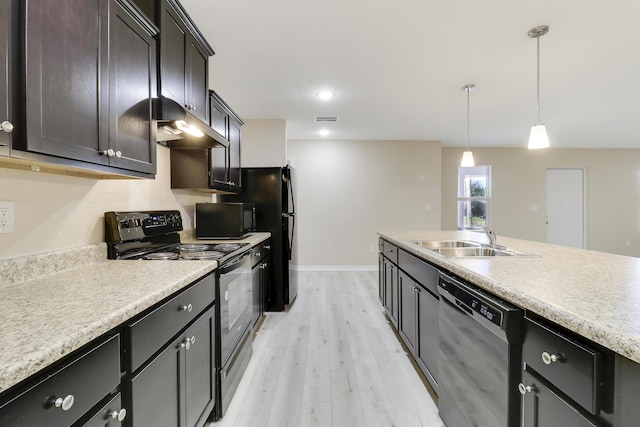 kitchen featuring sink, pendant lighting, light hardwood / wood-style floors, dark brown cabinets, and black appliances