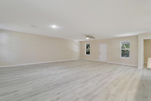 unfurnished room featuring light hardwood / wood-style flooring and ceiling fan