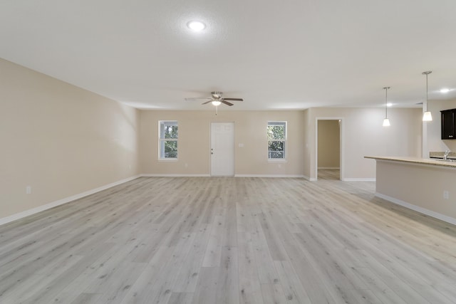 unfurnished living room featuring light hardwood / wood-style floors and ceiling fan