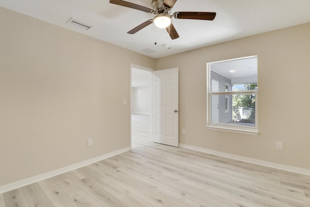 spare room with ceiling fan and light wood-type flooring