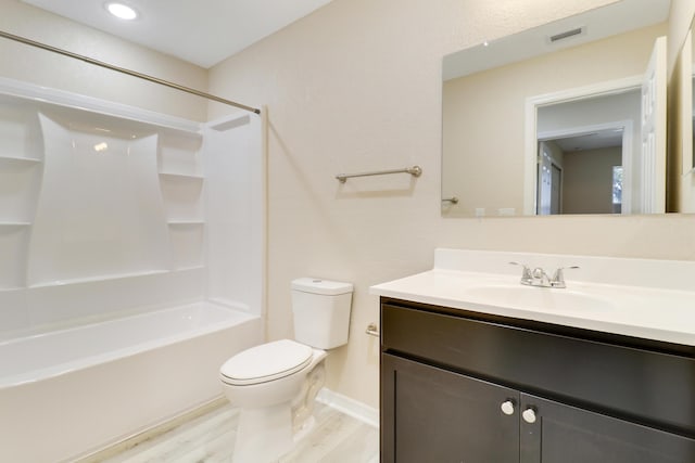 full bathroom featuring hardwood / wood-style floors, vanity, toilet, and  shower combination