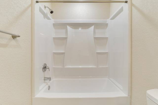 bathroom with shower / tub combination and toilet