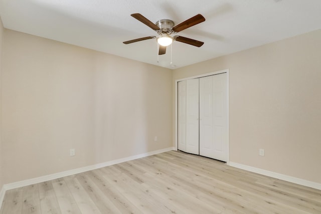 unfurnished bedroom featuring ceiling fan, a closet, and light hardwood / wood-style floors