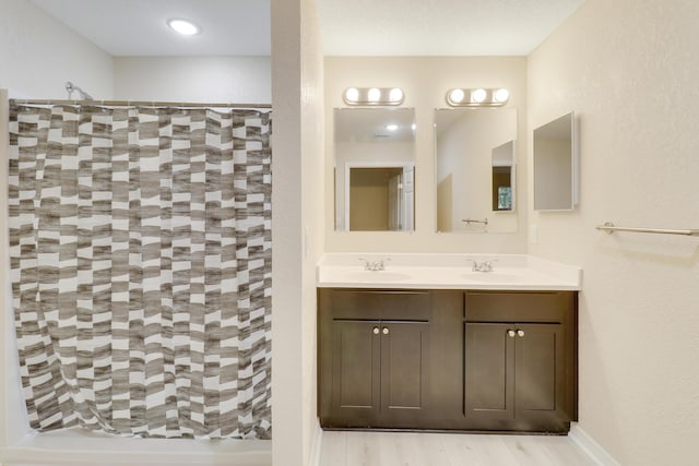 bathroom with vanity, wood-type flooring, and walk in shower