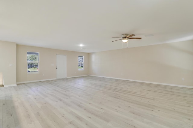 empty room featuring light wood-type flooring and ceiling fan