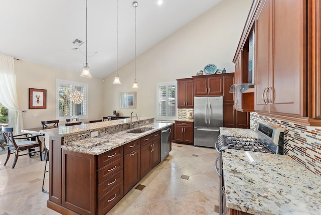 kitchen with a spacious island, decorative backsplash, sink, and stainless steel appliances