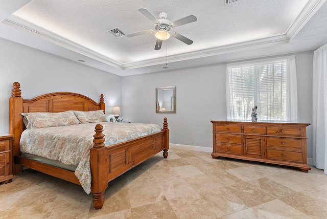 bedroom featuring a textured ceiling, a tray ceiling, ceiling fan, and crown molding