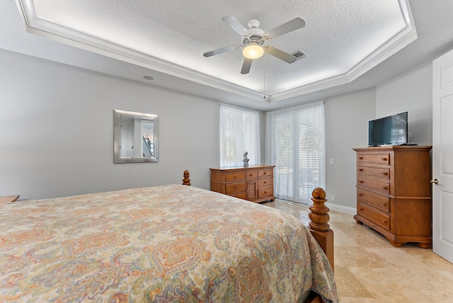 bedroom with ceiling fan, a raised ceiling, a textured ceiling, and crown molding