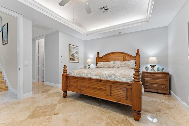 bedroom with ceiling fan and a textured ceiling