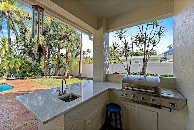 view of patio featuring a grill and sink