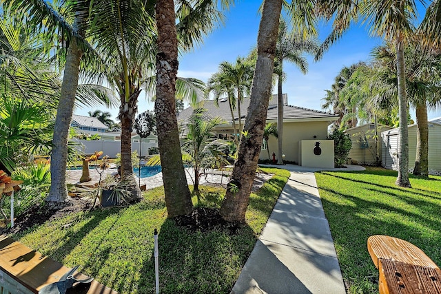 view of front facade with a fenced in pool and a front yard