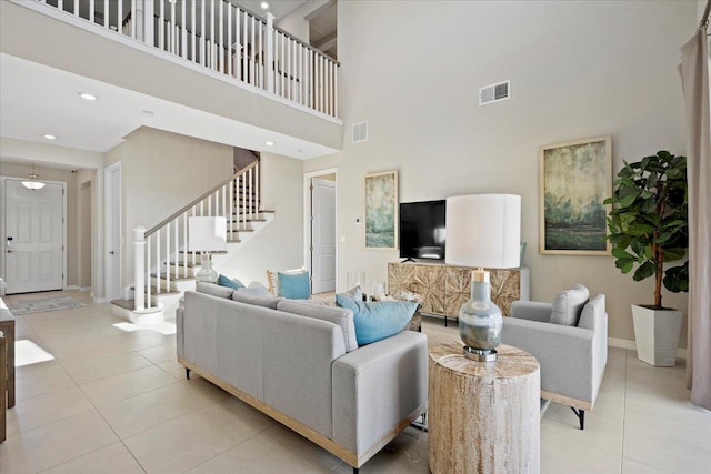 living room featuring light tile patterned floors and a high ceiling