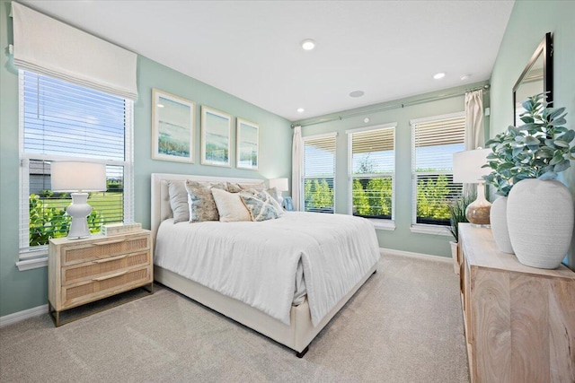 carpeted bedroom featuring multiple windows