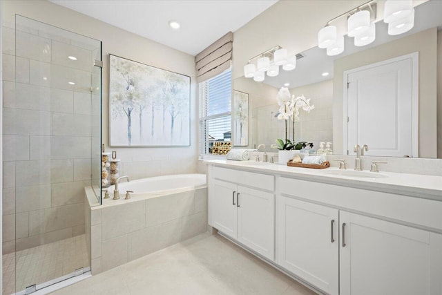 bathroom with tile patterned floors, vanity, and separate shower and tub