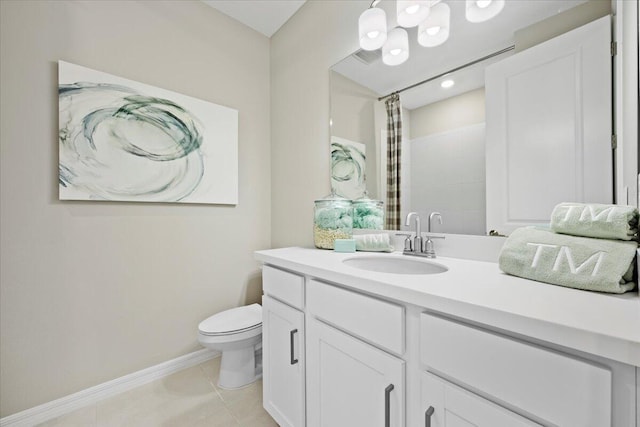 bathroom featuring tile patterned flooring, vanity, toilet, and walk in shower