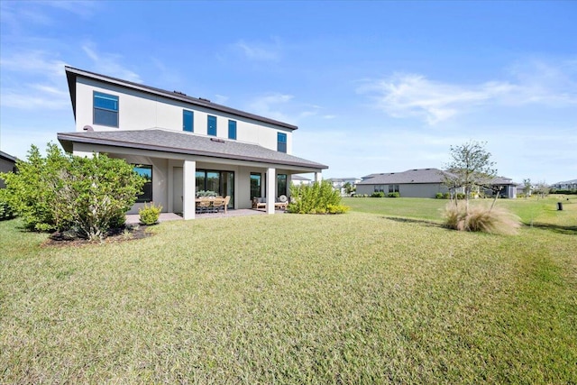 back of property featuring a patio area and a yard