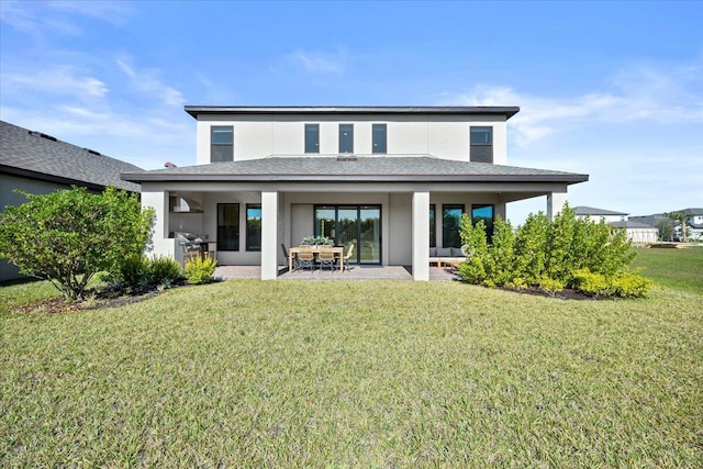 back of property with a patio area and a yard