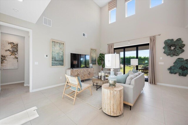 11966 SW Macelli Way, Port Saint Lucie, FL 34987 - living room featuring high vaulted ceiling, plenty of natural light, baseboards, and light tile patterned floors