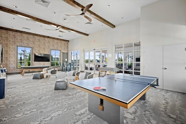 game room featuring carpet, a high ceiling, french doors, ceiling fan, and beamed ceiling