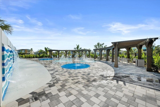 view of pool featuring a pergola, pool water feature, and a patio