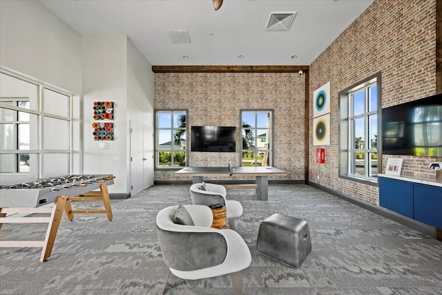 11966 SW Macelli Way, Port Saint Lucie, FL 34987 - carpeted living room with brick wall and a towering ceiling
