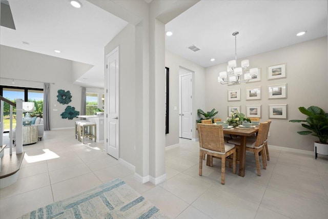 tiled dining space with a chandelier