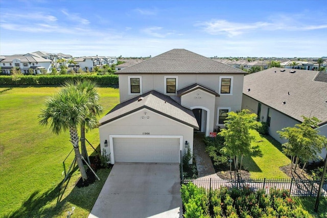 view of front facade with a front yard and a garage