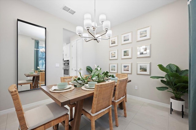 dining area featuring light tile patterned floors and a notable chandelier