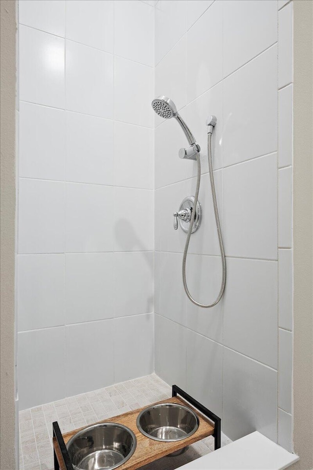 bathroom with tiled shower