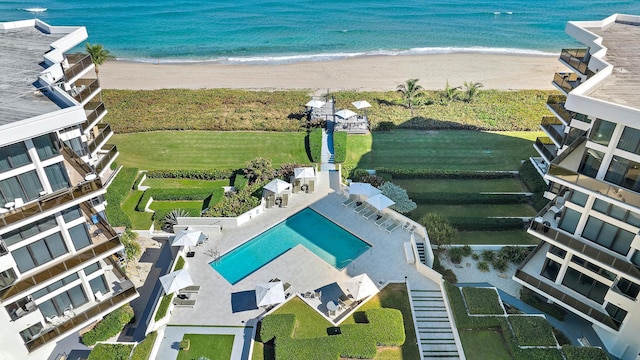 drone / aerial view featuring a beach view and a water view