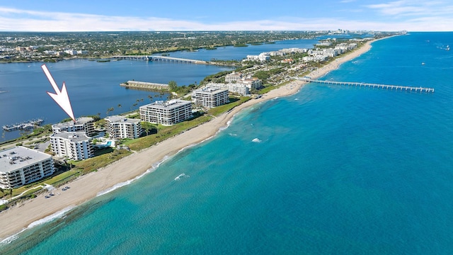 drone / aerial view with a water view and a view of the beach