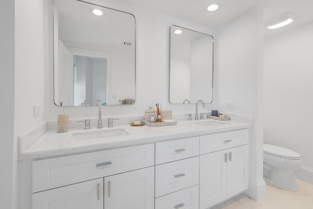 bathroom featuring vanity and toilet