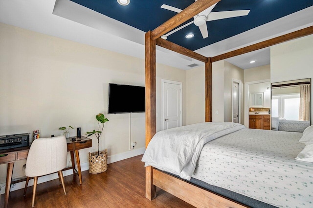 bedroom featuring ensuite bath, ceiling fan, and dark wood-type flooring