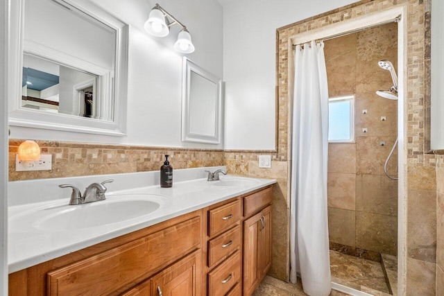 bathroom featuring vanity, curtained shower, and tile walls