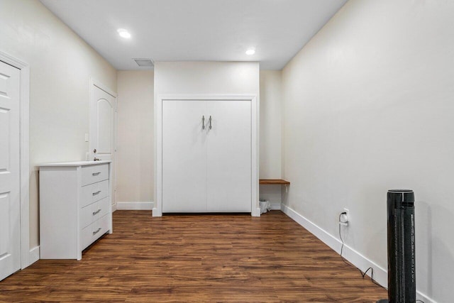 interior space featuring dark wood-style flooring, recessed lighting, visible vents, and baseboards